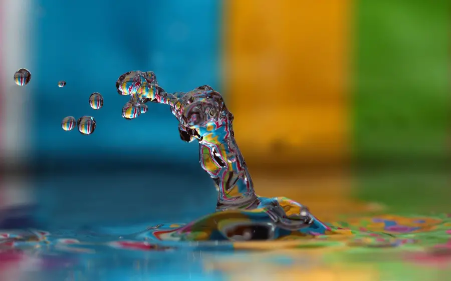 عکس قطره آب پرتاب شده با پس زمینه رنگارنگ و کیفیت فوق العاده